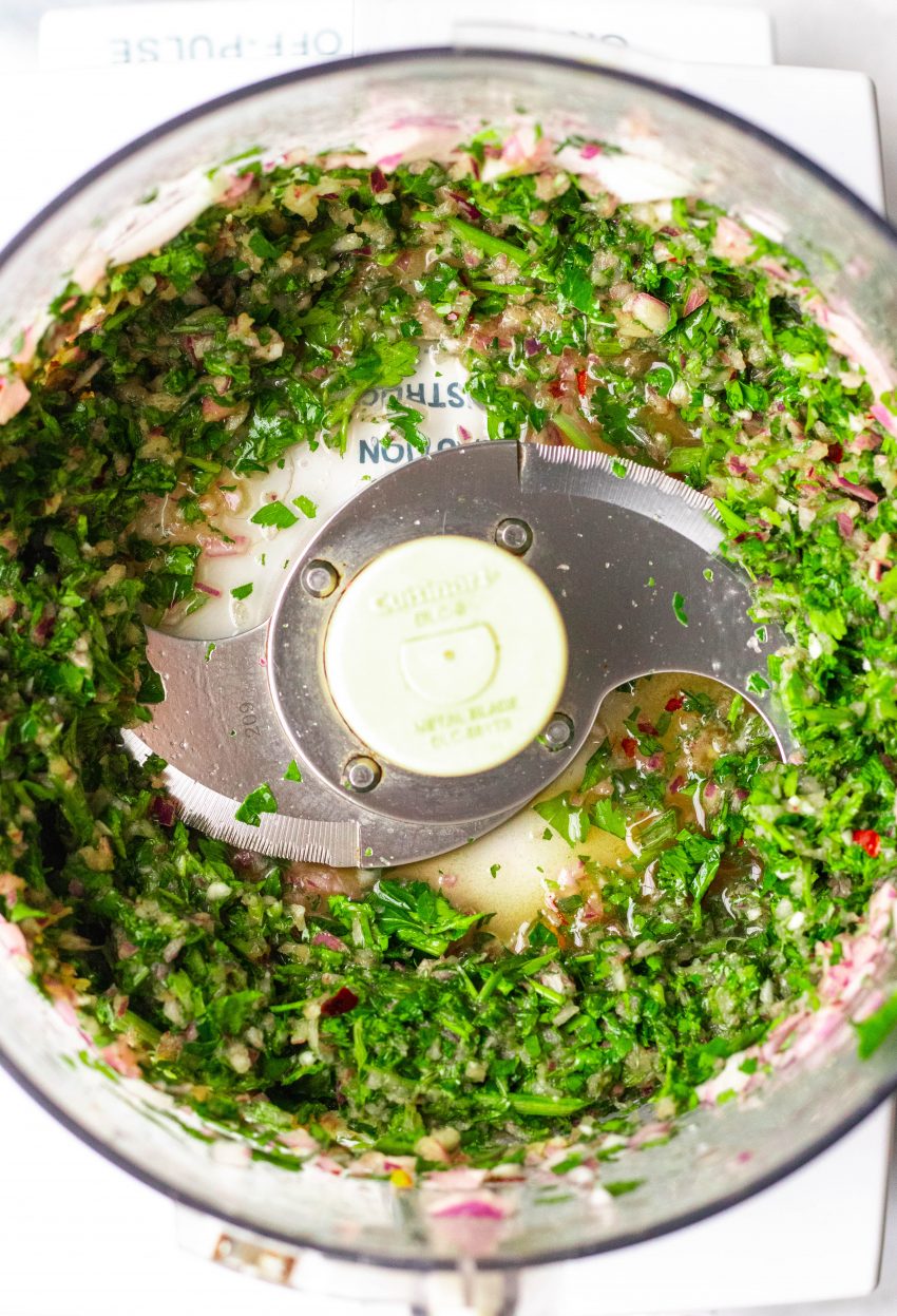 Chimichurri sauce being made in a food processor