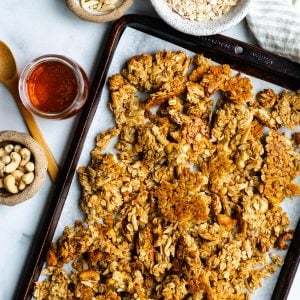 tray of honey nut granola with bowls of ingredients surrounding