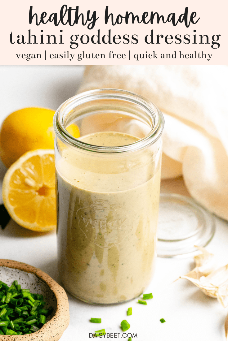 Healthy Tahini Goddess Dressing in a jar with ingredients around the jar