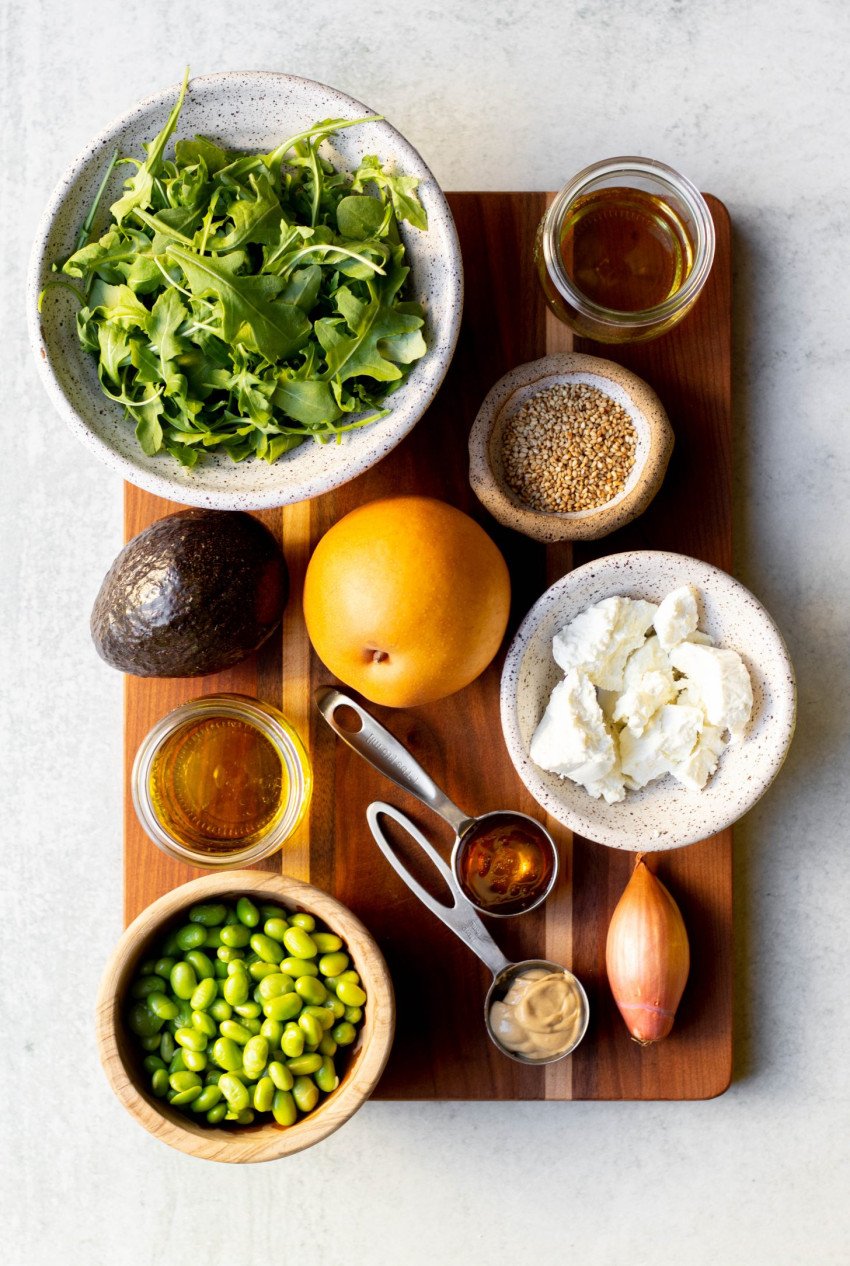 Asian pear salad ingredients measured out on a wooden cutting board