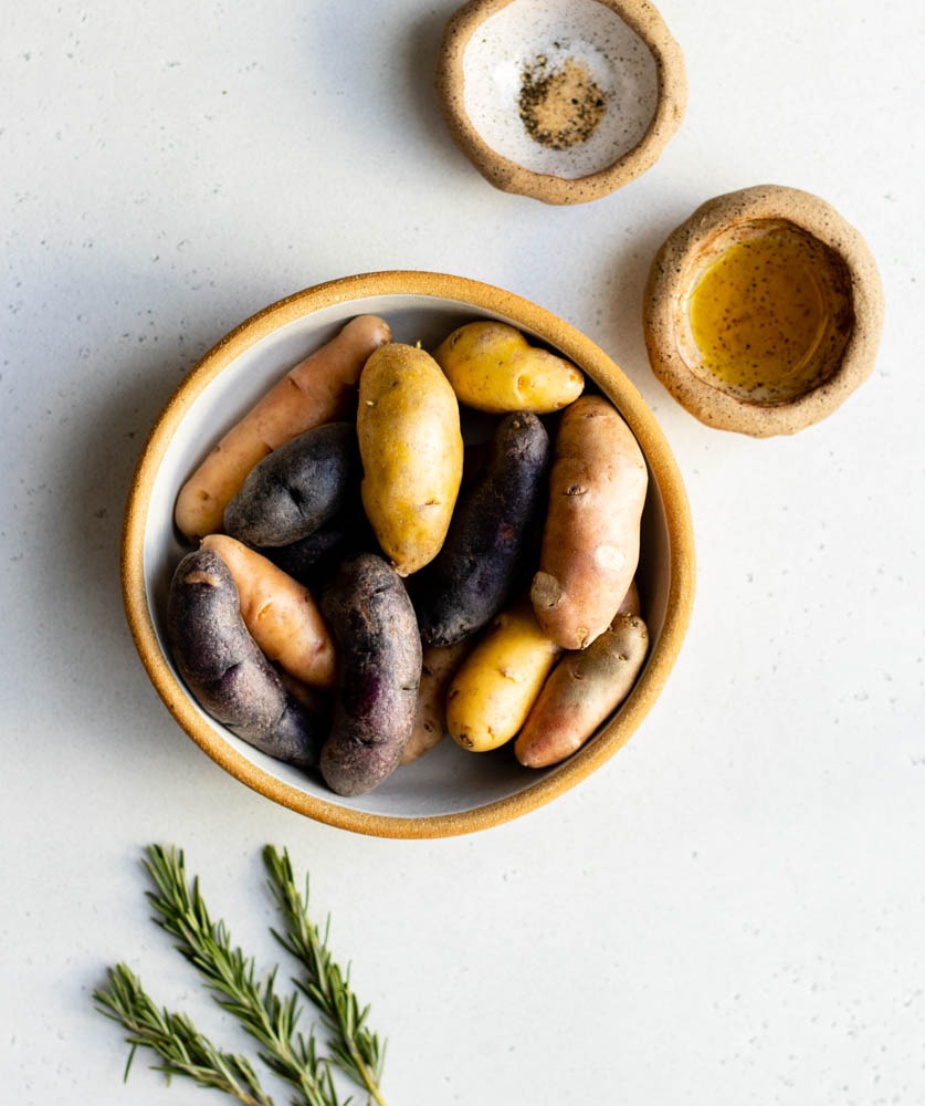 Air fryer fingerling potatoes ingredients measured out in bowls on grey backdrop
