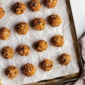 No bake energy bites on a parchment paper lined baking sheet
