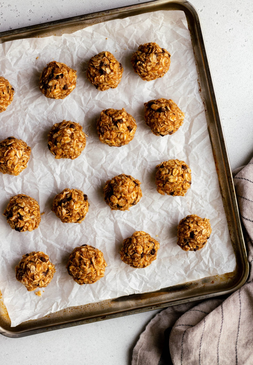 Tray lined with parchment paper holding no bake granola bites
