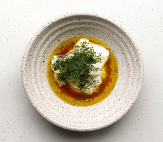 Greek yogurt salad dressing ingredients in a speckled bowl