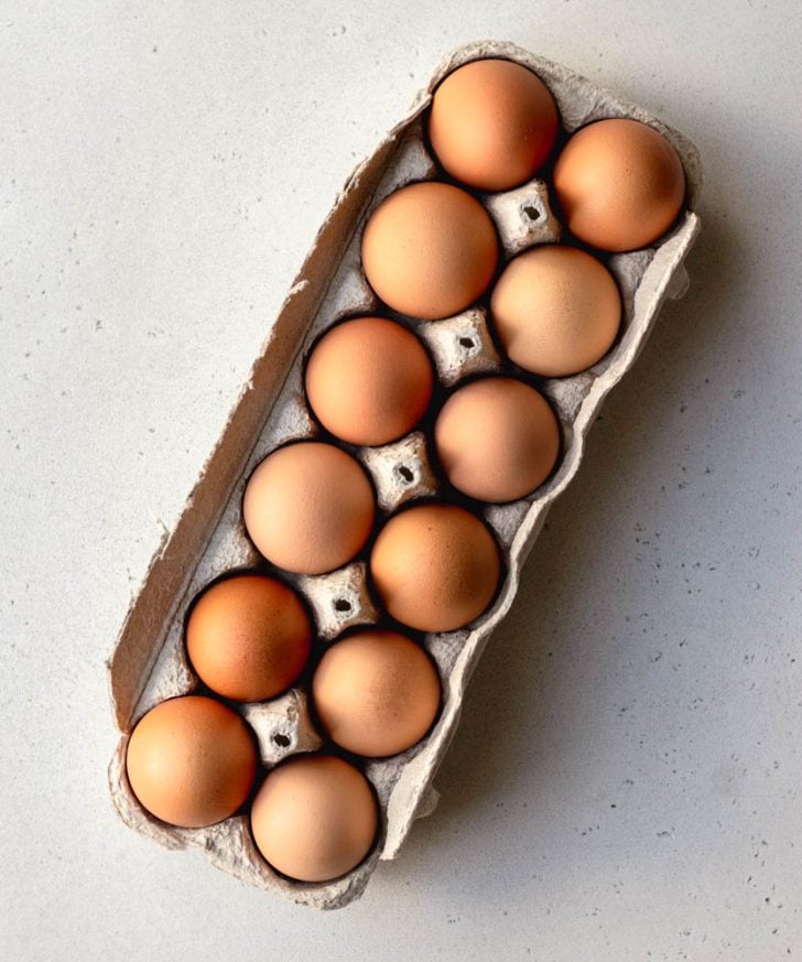 Dozen brown eggs in a cardboard egg box