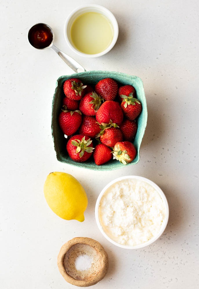 Roasted strawberry and ricotta toast ingredients measured out on a white backdrop