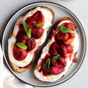 plate with two pieces of ricotta and strawberry toast