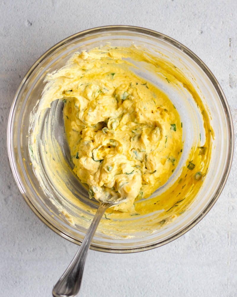 Creamy egg salad in a glass mixing bowl