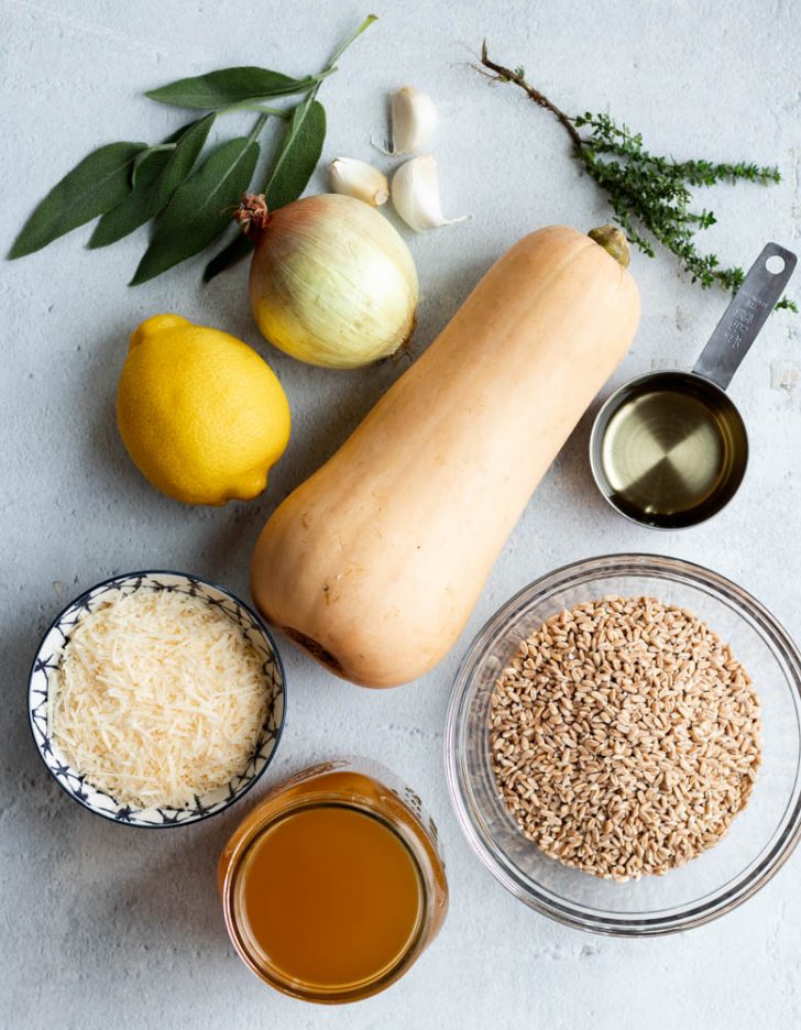 butternut squash farro risotto ingredients measured out on a light grey backdrop