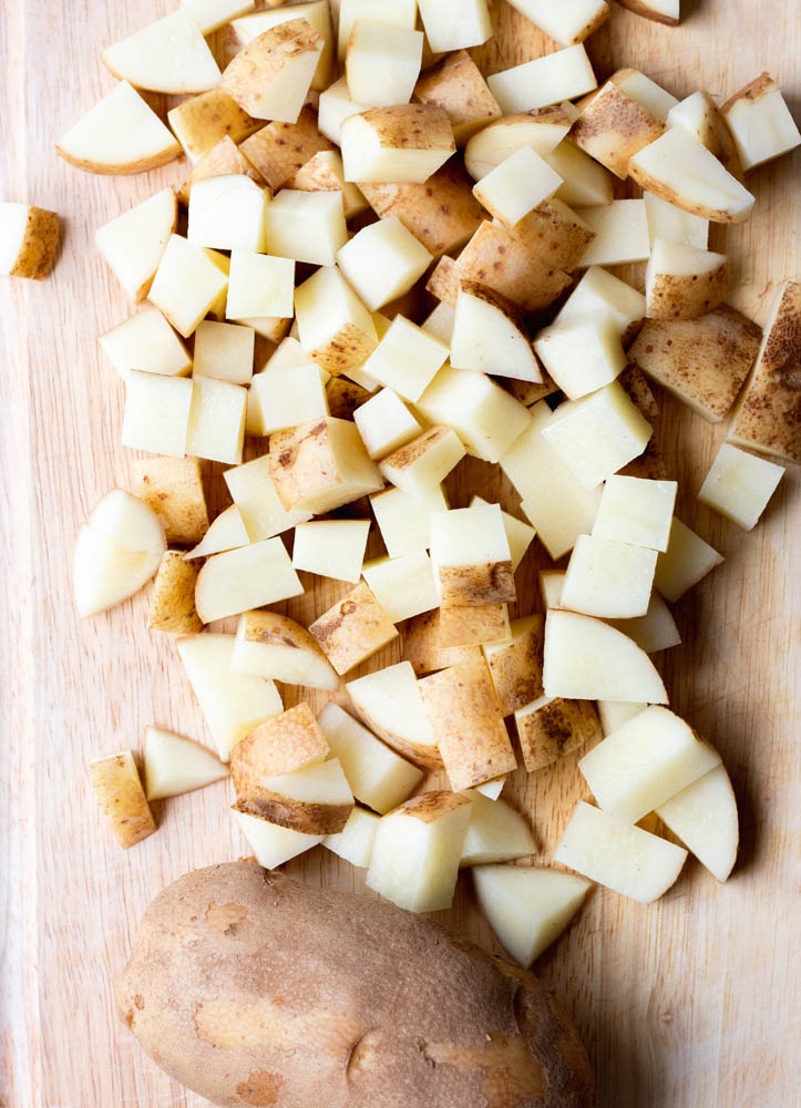 Diced potatoes on a wooden cutting board