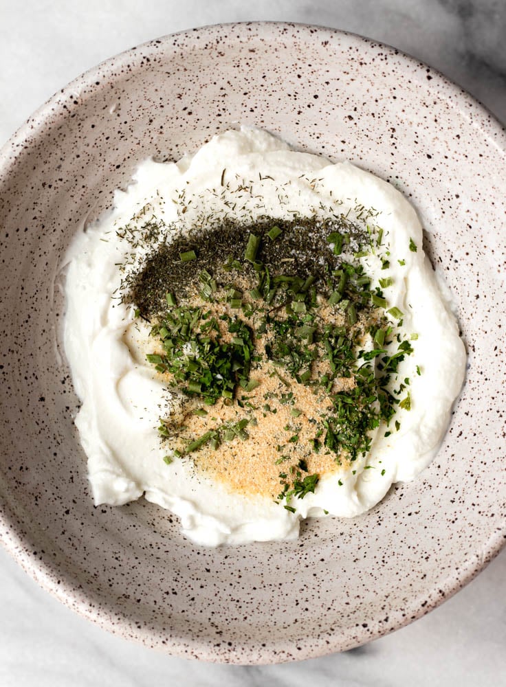 Greek yogurt in a bowl with ranch seasoning sprinkled on top