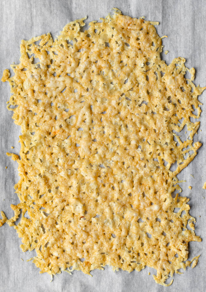 crispy parmesan crisp on a piece of parchment paper