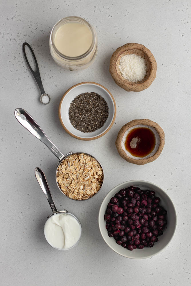 blueberry pie ingredients measured out on a light grey backdrop