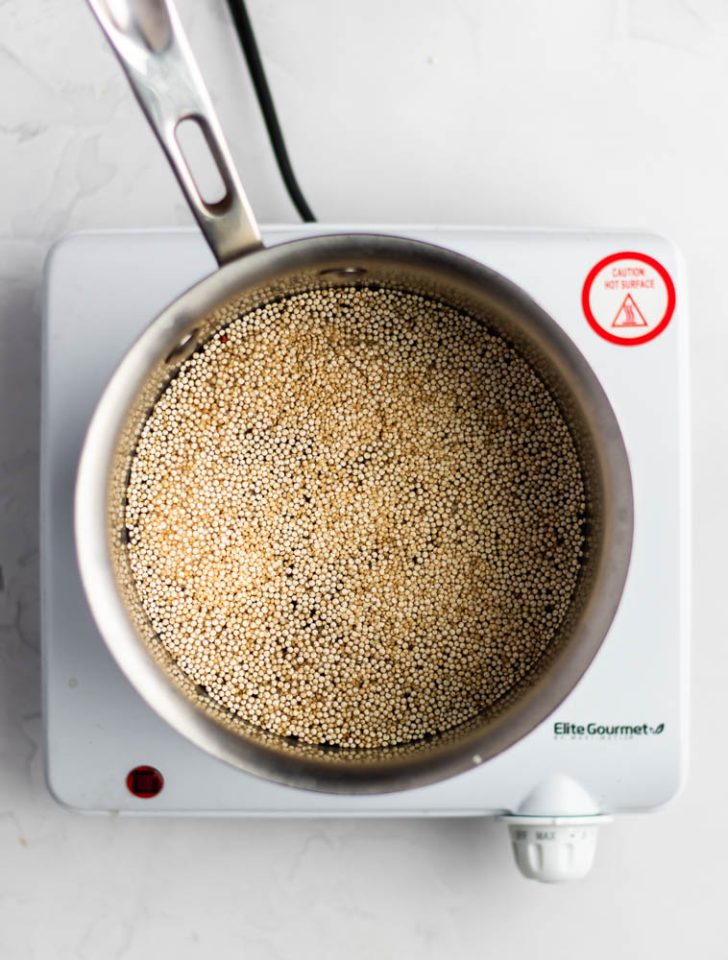 Saucepan with quinoa and water on a electric burner 