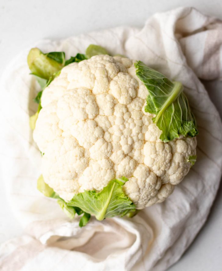 Head of cauliflower on a white dish towel
