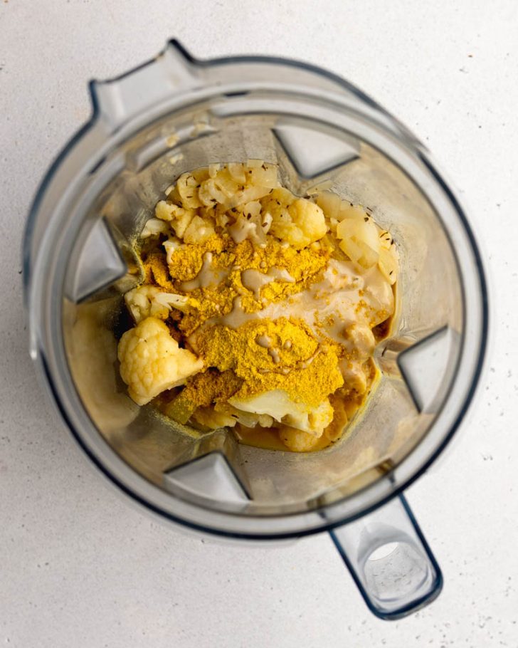 cauliflower alfredo sauce ingredients in a blender before being blended