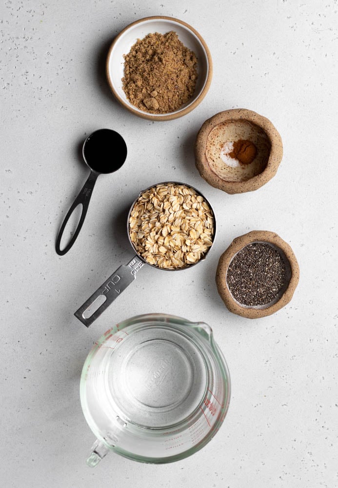 oatmeal with chia and flax ingredients measured out on a light grey backdrop