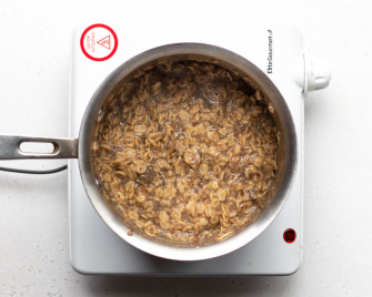 Pot of oatmeal on a white burner
