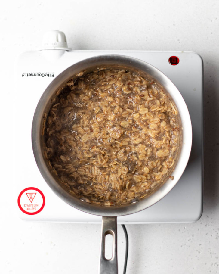 Pot of oatmeal on a white burner