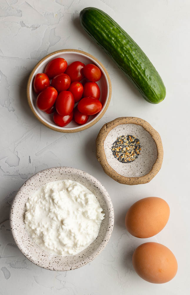 cottage cheese breakfast bowls ingredients measured out on light grey backdrop