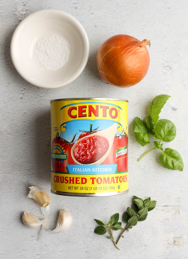 marinara sauce ingredients on a light grey backdrop