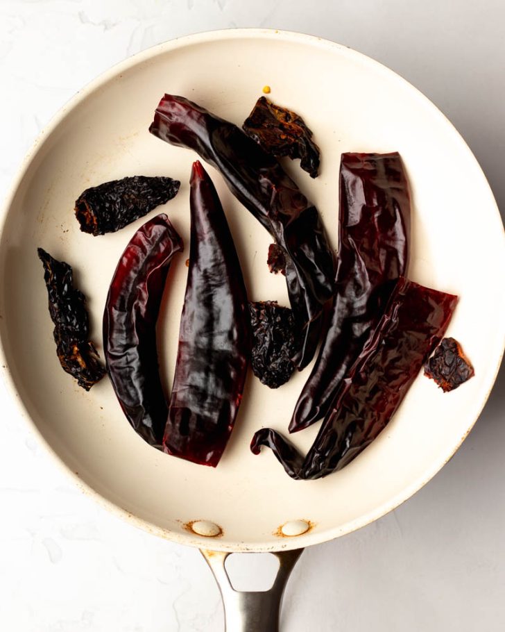 dried chiles in a white skillet