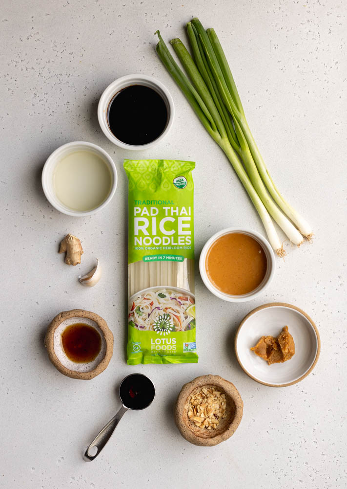 rice noodles with peanut sauce ingredients measured out on a light grey backdrop