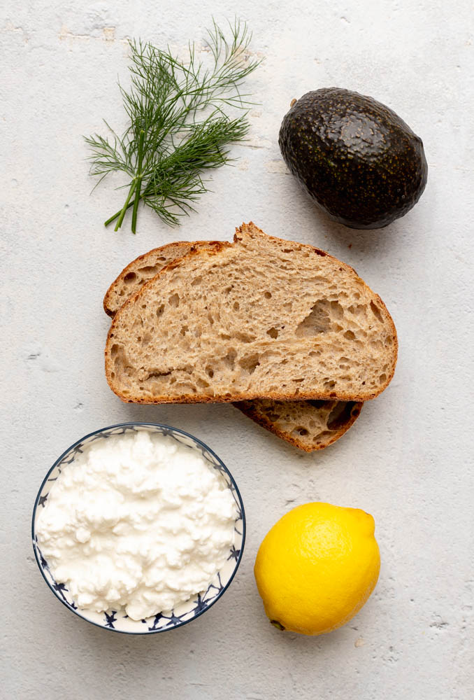 cottage cheese avocado toast ingredients measured out on a light grey backdrop