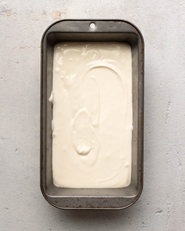 frozen greek yogurt in a metal loaf pan 