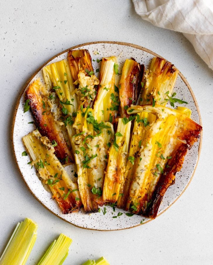 speckled white plate of roasted leeks