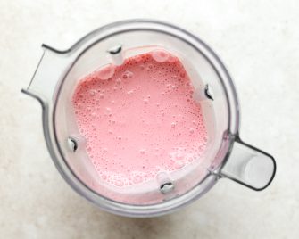 blended strawberry greek yogurt popsicles before being poured into popsicle molds