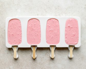 4 strawberry greek yogurt popsicles in molds