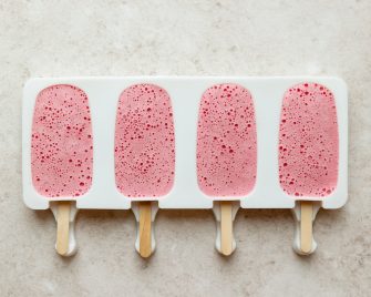 4 strawberry greek yogurt popsicles in molds
