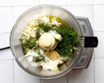 Feta dill dressing in a food processor before being blended