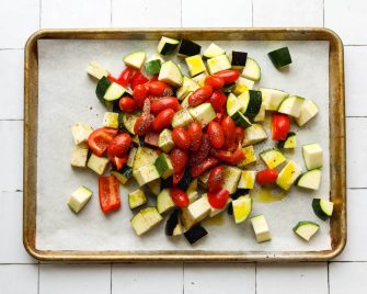Mixed vegetables on a parchment paper lined baking sheet