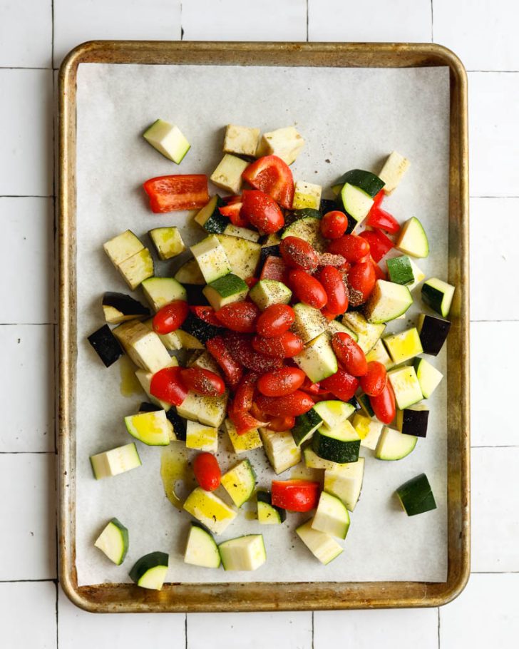 Mixed vegetables on a parchment paper lined baking sheet