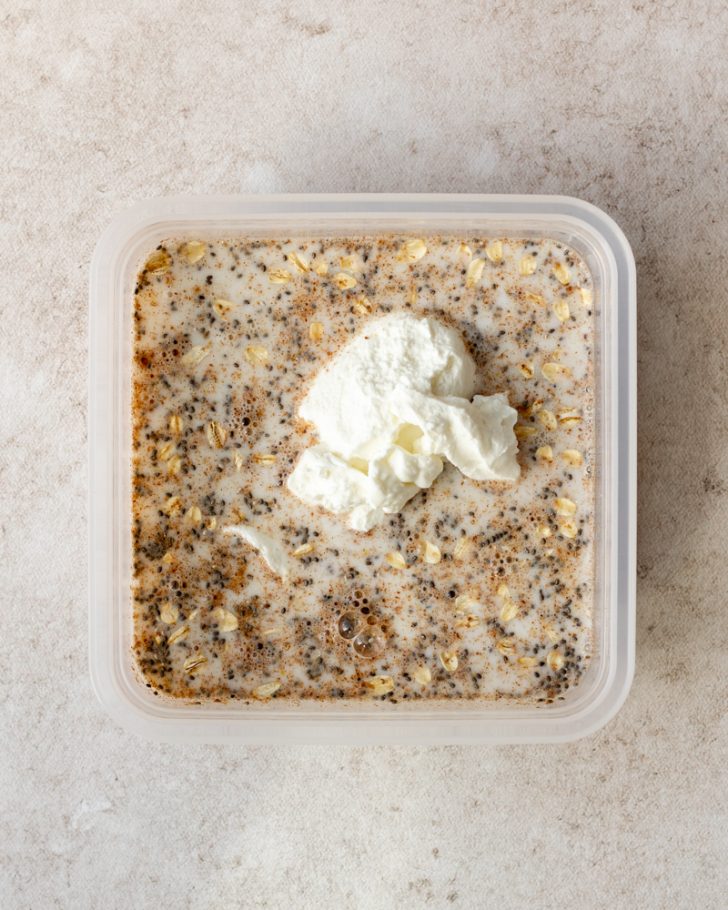overnight oats ingredients in a tupperware before being mixed together
