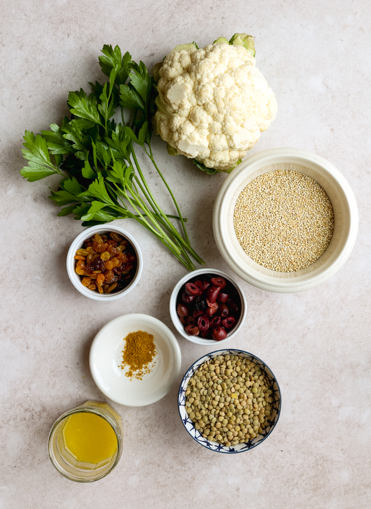 quinoa lentil salad ingredients measured out  on a light backdrop