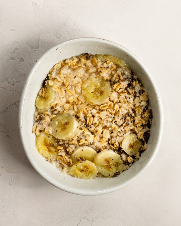 microwaved oatmeal with banana in a bowl