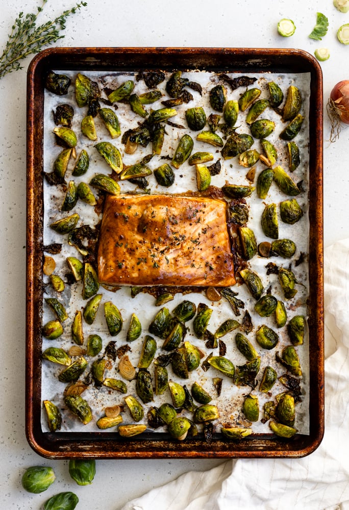 salmon and brussels sprouts roasted together on a sheet pan