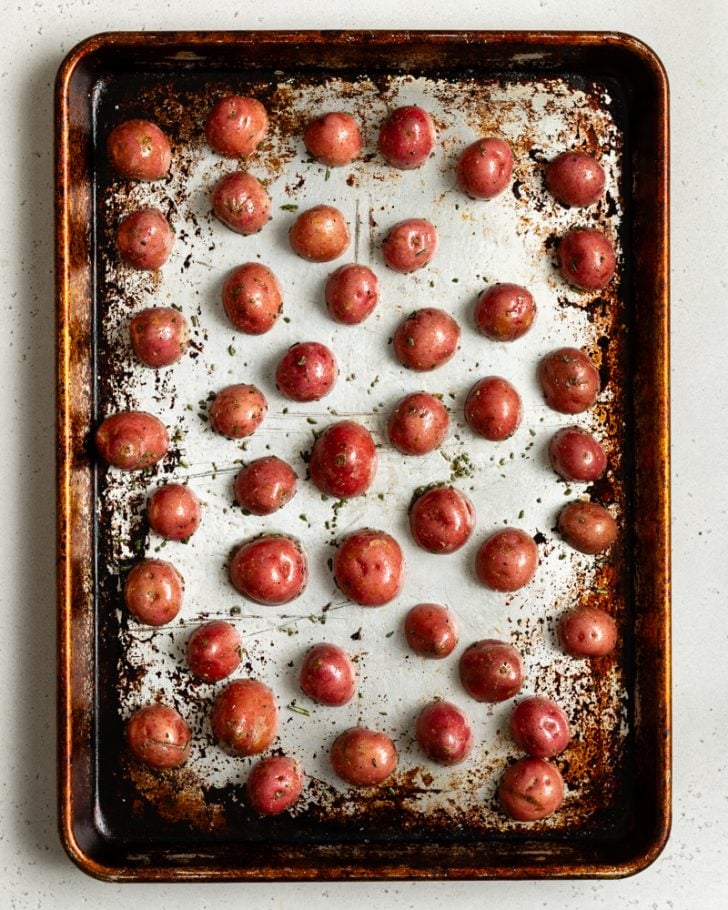 red baby potatoes on a baking sheet