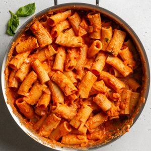 rigatoni pasta in a creamy red sauce in a saute pan
