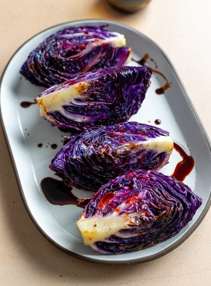 oval plate with 4 roasted red cabbage wedges