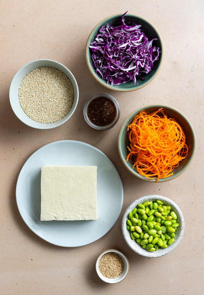 quinoa tofu bowl ingredients measured out in bowls