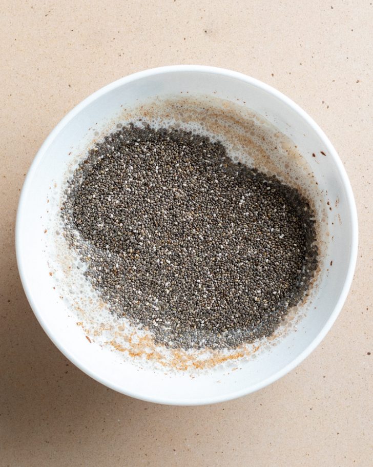 chia pudding in a white bowl before being mixed up