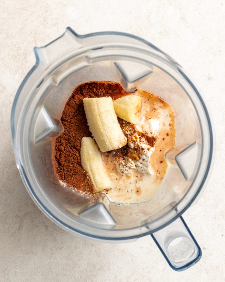 chocolate peanut butter protein shake ingredients in a blender