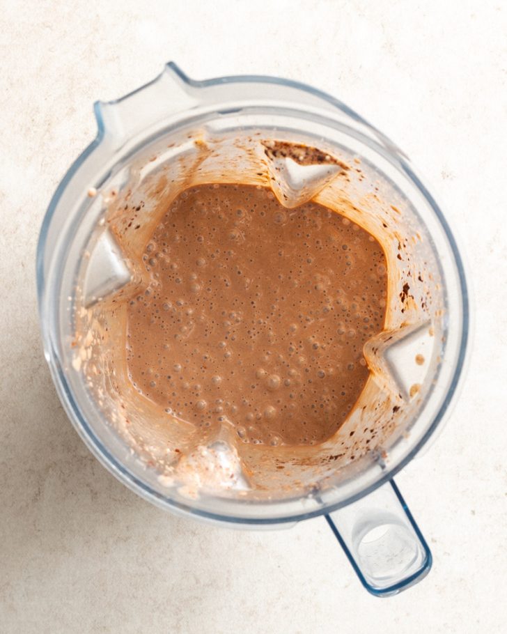 chocolate peanut butter protein shake blended up in a blender