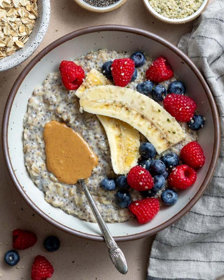 bowl of oatmeal with fresh fruit and peanut butter